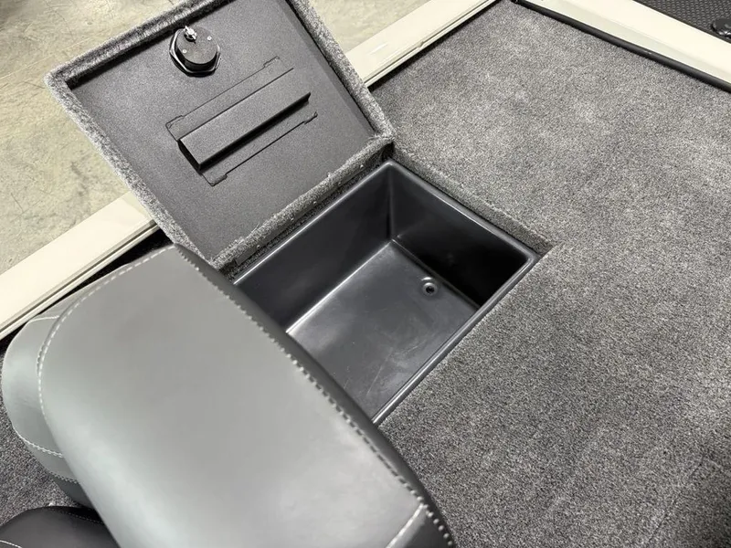 Slide: The Image of 2025 Tracker Savage 215 boat storage compartment with open lid and gray upholstery. - 15