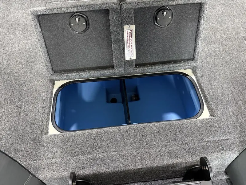 Slide: The Image of 2025 Tracker Savage 215 boat storage compartment with open hatch, revealing blue interior. - 17