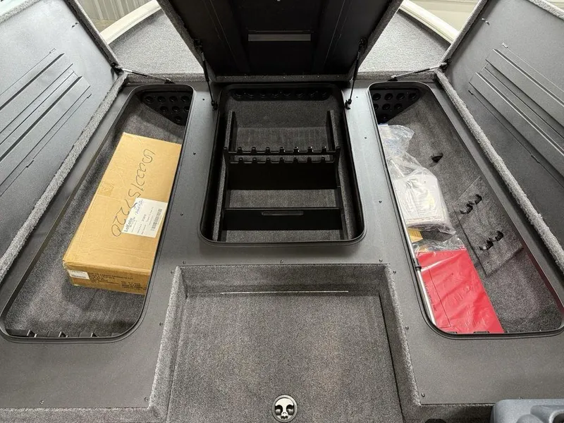 Slide: The Image of 2025 Tracker Savage 215 boat storage compartments with organized gear and accessories. - 6