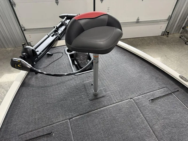 Slide: The Image of 2025 Tracker Savage 215 boat interior with fishing seat and trolling motor. - 8