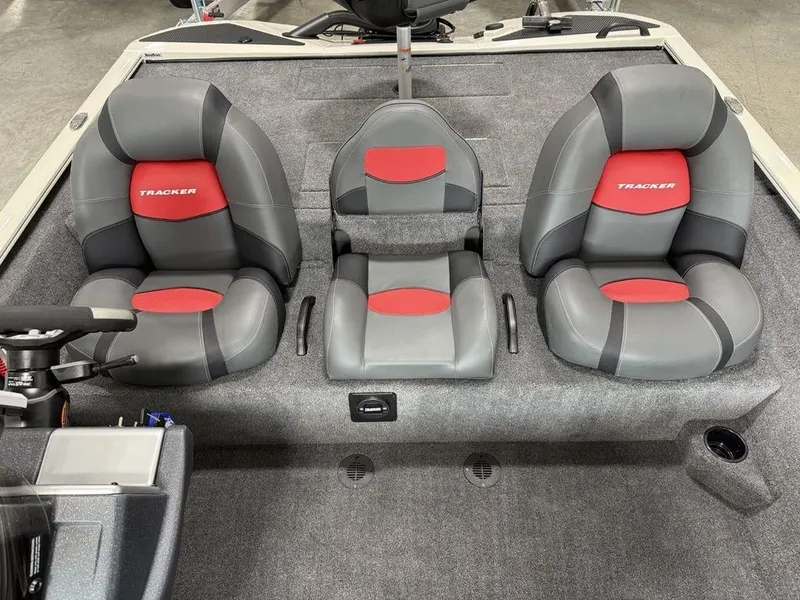 Slide: The Image of 2025 Tracker Savage 215 boat interior with three gray and red cushioned seats. - 9