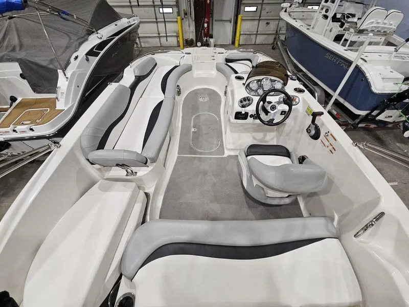 Slide: The Image of 2014 Starcraft Limited IO 2000 I/O boat interior with seating and steering wheel. - 11