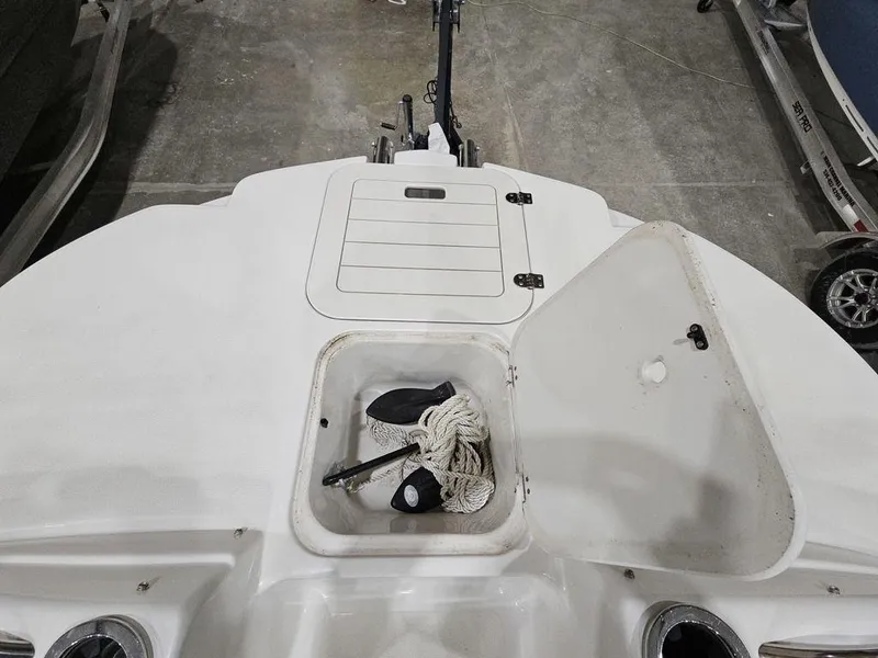 Slide: The Image of 2014 Starcraft Limited IO 2000 I/O boat storage compartment with rope and accessories. - 12
