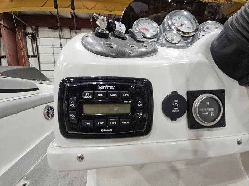 Slide: The Image of Control panel of a 2014 Starcraft Limited IO 2000 I/O boat with Infinity audio system. - 16