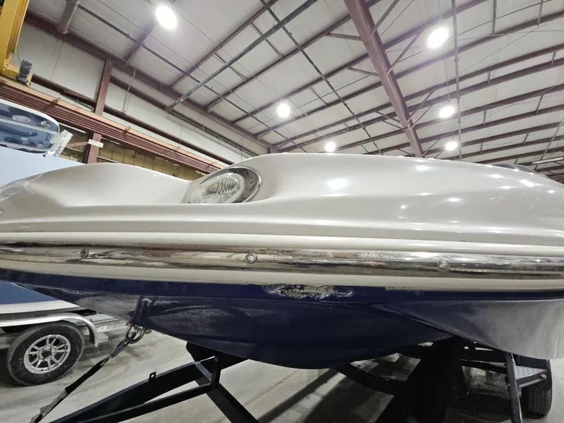 Slide: The Image of 2014 Starcraft Limited IO 2000 I/O boat in indoor storage facility. - 19