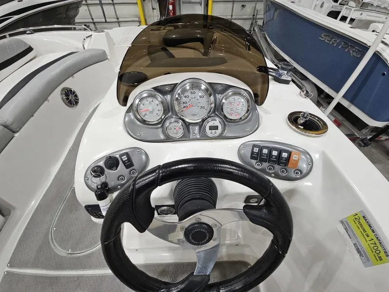Slide: The Image of 2014 Starcraft Limited IO 2000 I/O boat dashboard with steering wheel and gauges. - 4