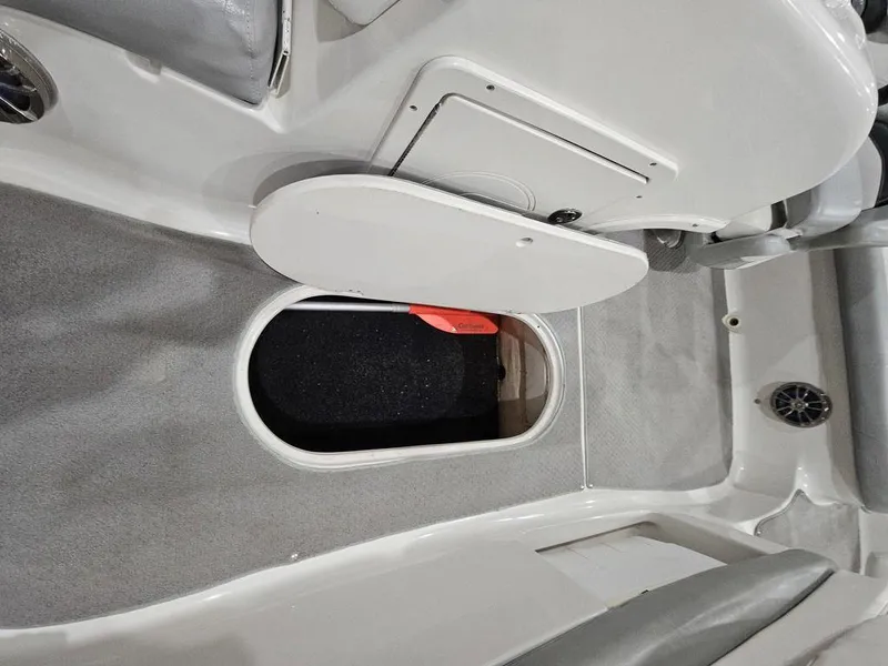 Slide: The Image of 2014 Starcraft Limited IO 2000 I/O boat interior storage compartment open. - 5