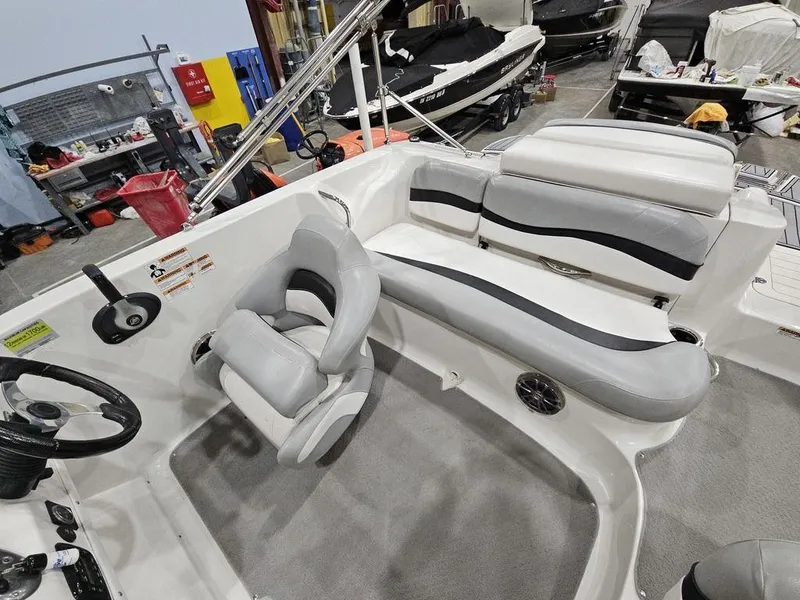 Slide: The Image of 2014 Starcraft Limited IO 2000 I/O boat interior with gray seating and steering wheel. - 6