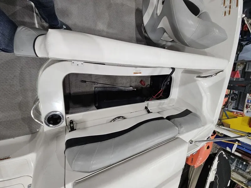 Slide: The Image of 2014 Starcraft Limited IO 2000 I/O boat interior with gray seating and storage compartment. - 7