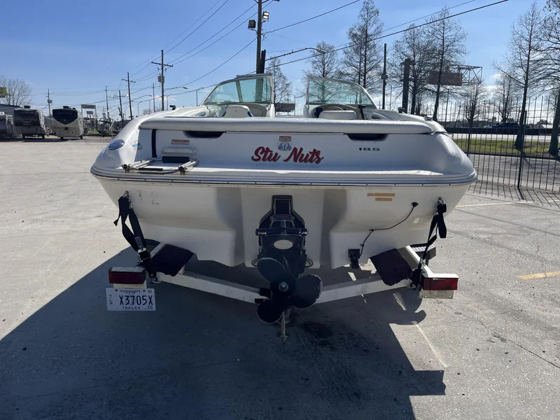 Slide: The Image of 1997 Sea Ray 185 boat on trailer, parked outdoors, rear view. - 11