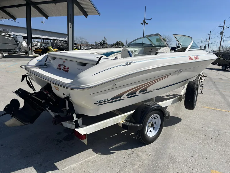 Slide: The Image of 1997 Sea Ray 185 boat on trailer in outdoor setting. - 5