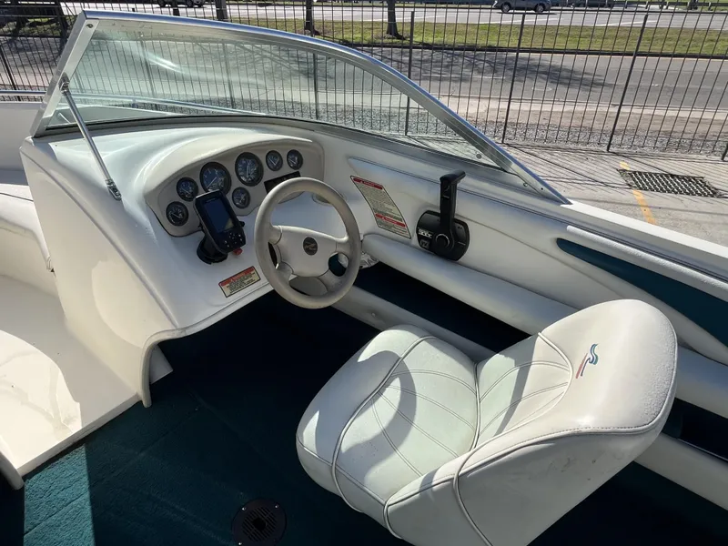Slide: The Image of 1997 Sea Ray 185 boat interior with steering wheel and dashboard controls. - 6