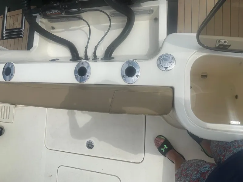 Slide: The Image of 2019 Scout 255 Dorado boat interior with rod holders and seating area. - 23