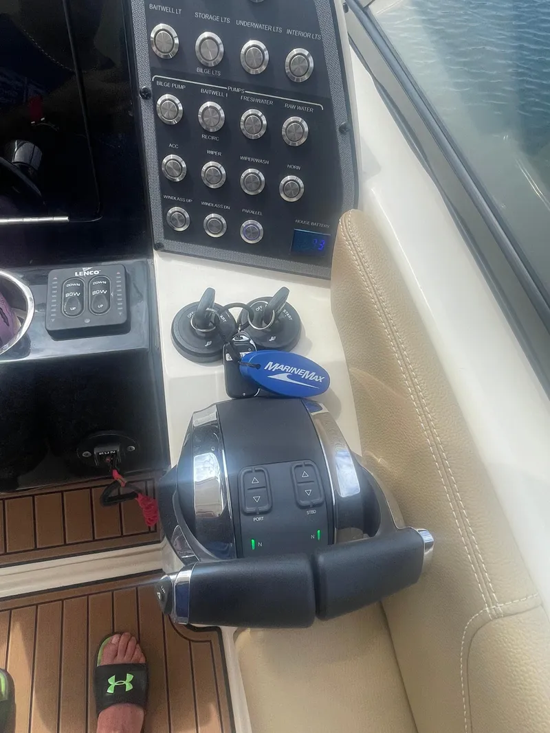 Slide: The Image of Control panel of a 2019 Scout 255 Dorado boat with throttle and switches. - 25