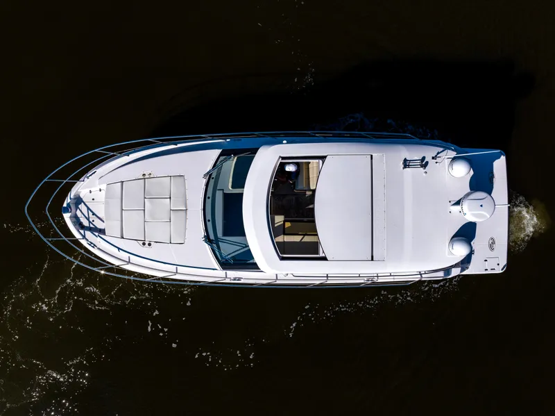 Slide: The Image of Aerial view of 2021 Regal 38 Grande Coupe yacht on dark water. - 26