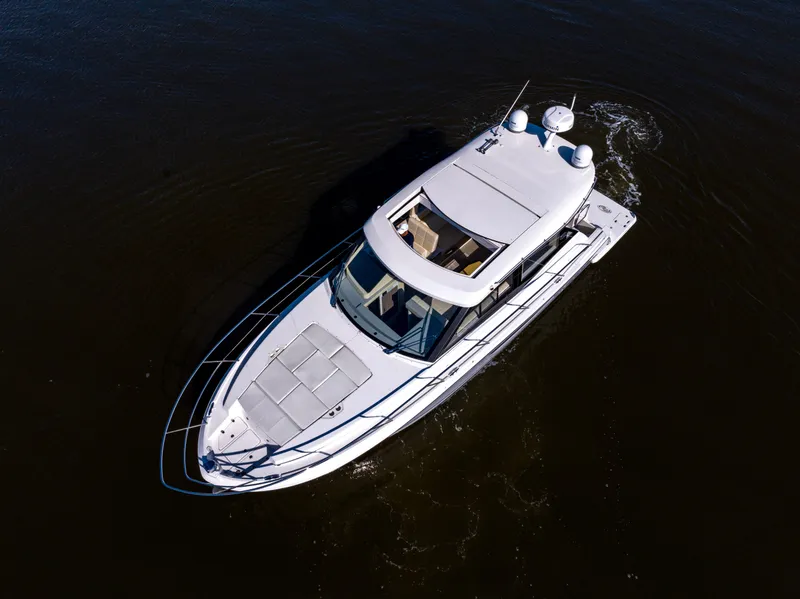 Slide: The Image of 2021 Regal 38 Grande Coupe cruising on dark water, aerial view. - 27