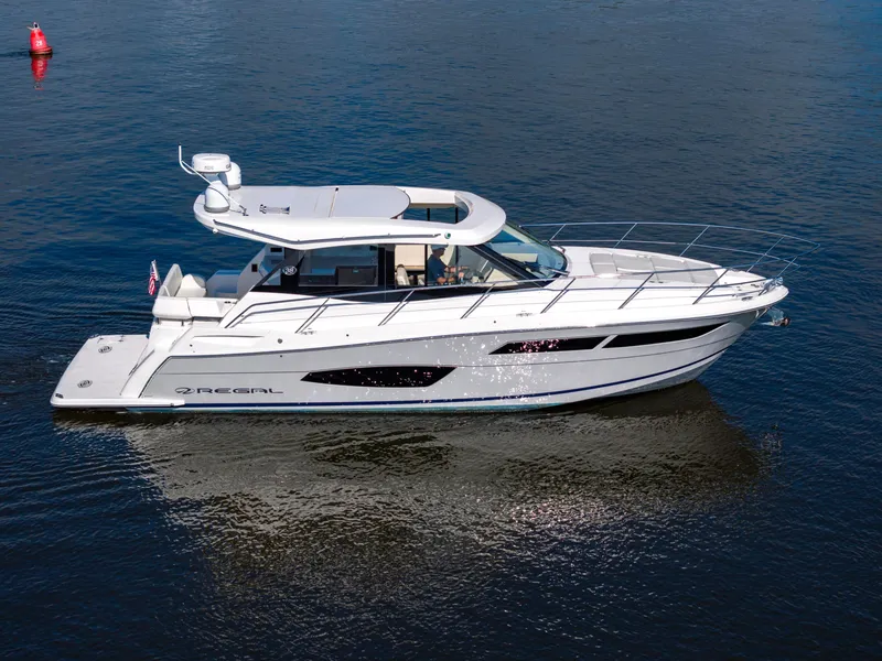 Slide: The Image of 2021 Regal 38 Grande Coupe yacht cruising on calm waters. - 3