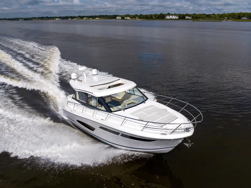 Slide: The Image of 2021 Regal 38 Grande Coupe cruising on a calm river. - 31