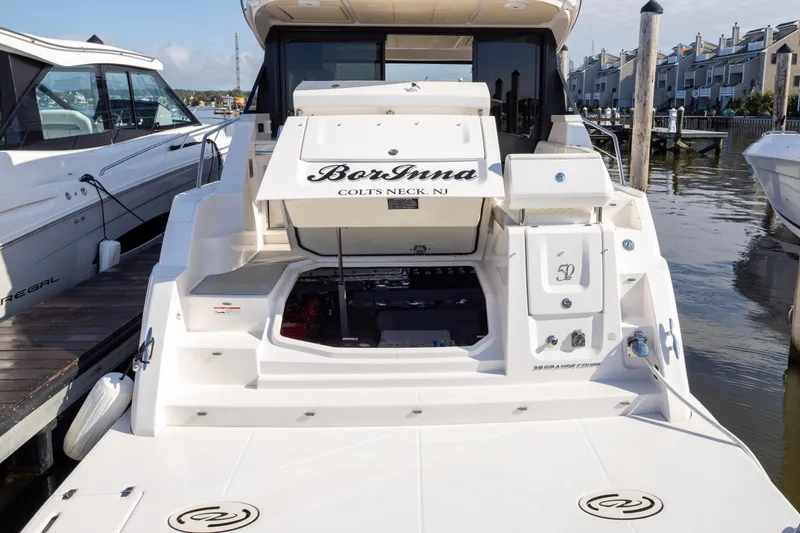Slide: The Image of 2021 Regal 38 Grande Coupe yacht docked at marina, rear view. - 41