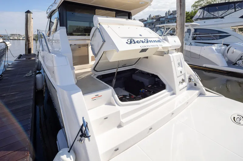 Slide: The Image of 2021 Regal 38 Grande Coupe yacht docked, showcasing open storage compartment. - 42