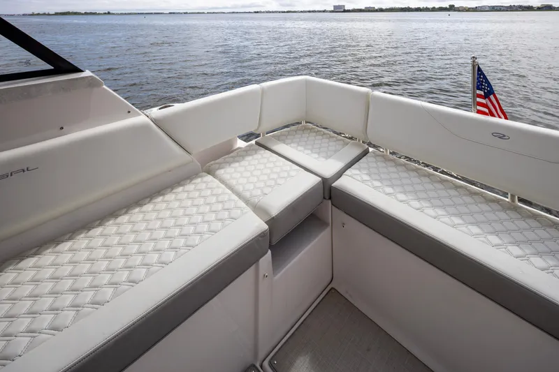 Slide: The Image of 2021 Regal 38 Grande Coupe yacht with elegant seating, overlooking serene waters. - 43