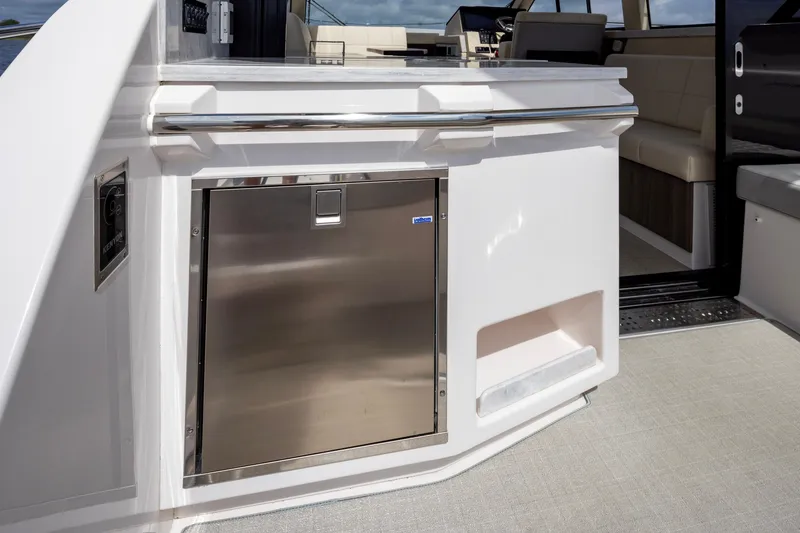 Slide: The Image of 2021 Regal 38 Grande Coupe yacht interior with stainless steel cabinet and seating area. - 46