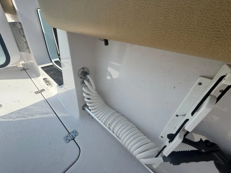 Slide: The Image of 2023 Sportsman Open 282 Center Console boat interior detail with coiled hose. - 25