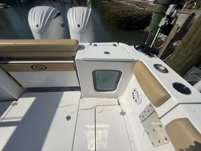 Slide: The Image of 2023 Sportsman Open 282 Center Console boat interior with seating and dual engines. - 12
