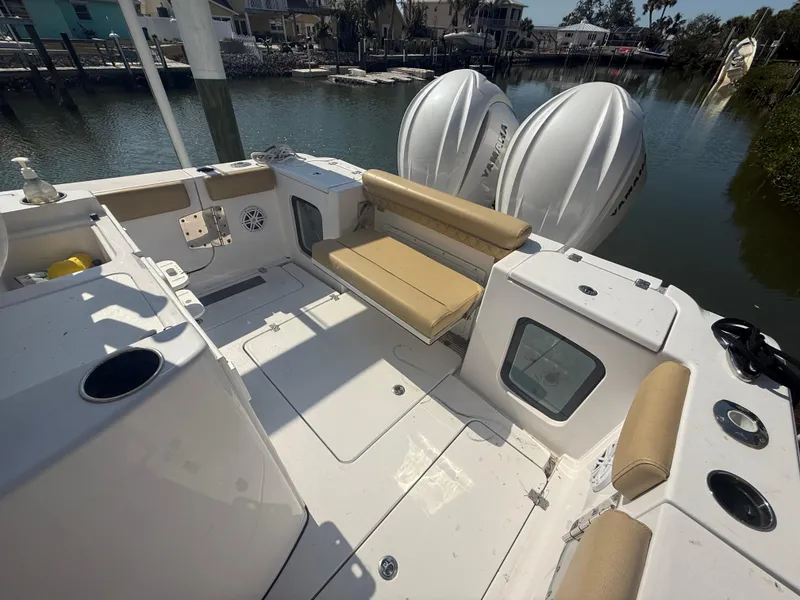 Slide: The Image of 2023 Sportsman Open 282 Center Console boat with dual engines, docked in a serene marina. - 11