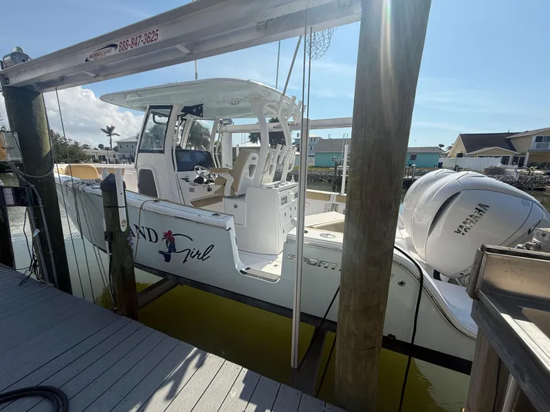 Slide: The Image of 2023 Sportsman Open 282 Center Console boat docked in marina, side view. - 6