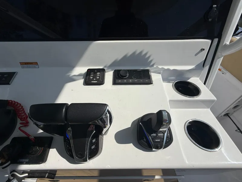 Slide: The Image of 2023 Sportsman Open 282 Center Console dashboard with controls and cup holders. - 33