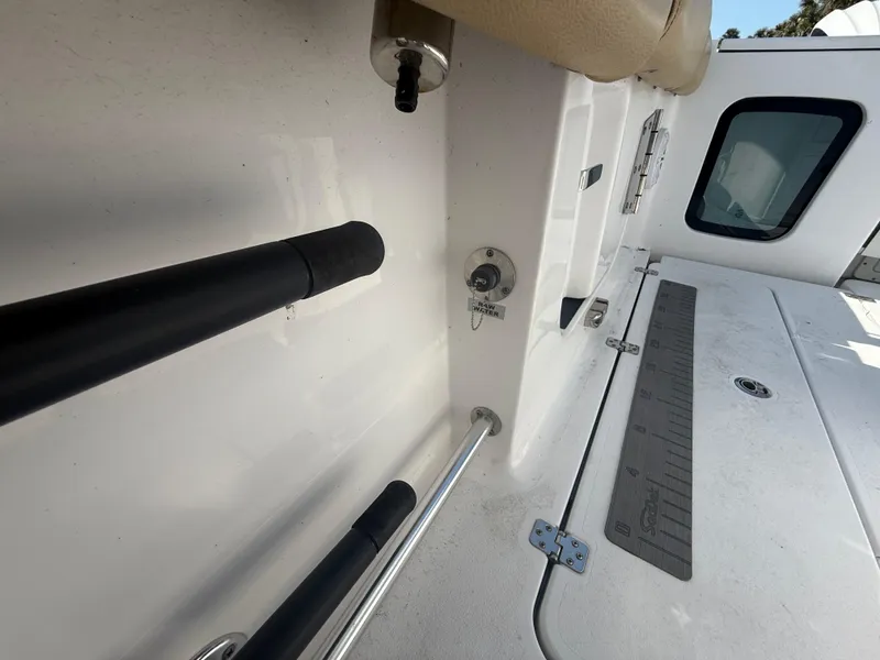 Slide: The Image of 2023 Sportsman Open 282 Center Console boat interior with rod holders and storage. - 24
