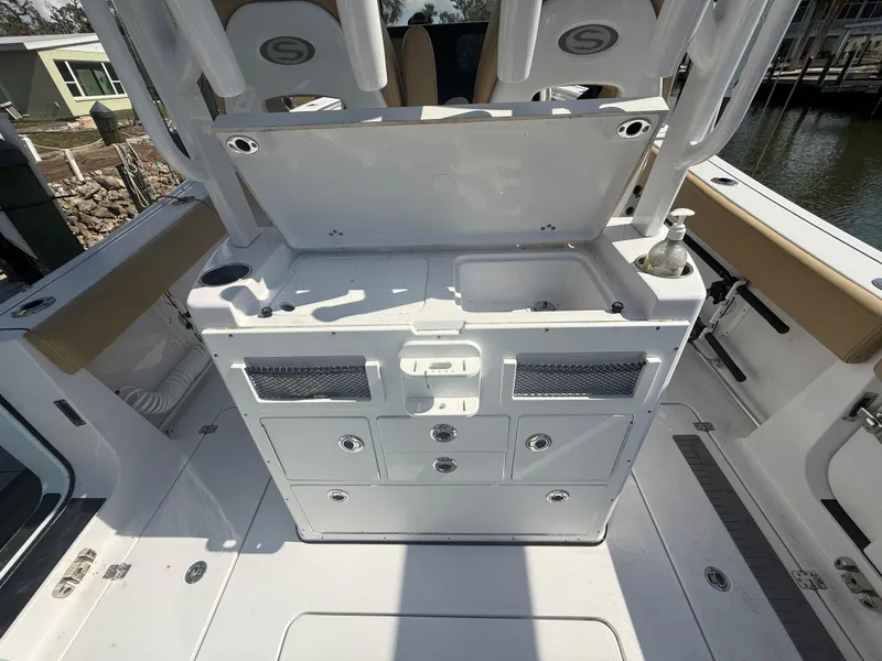 Slide: The Image of 2023 Sportsman Open 282 Center Console boat interior with storage and seating. - 19