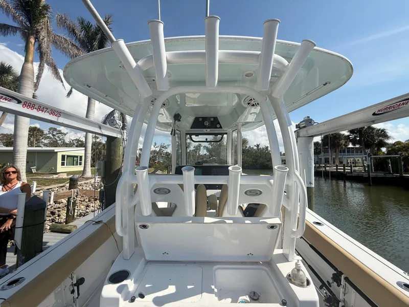 Slide: The Image of 2023 Sportsman Open 282 Center Console boat docked under sunny skies. - 20