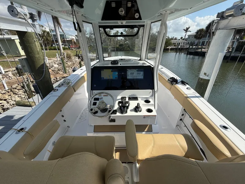 Slide: The Image of 2023 Sportsman Open 282 Center Console boat interior with helm and seating. - 39