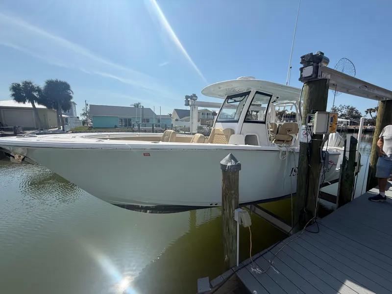 Slide: The Image of 2023 Sportsman Open 282 Center Console boat docked in sunny marina. - 7