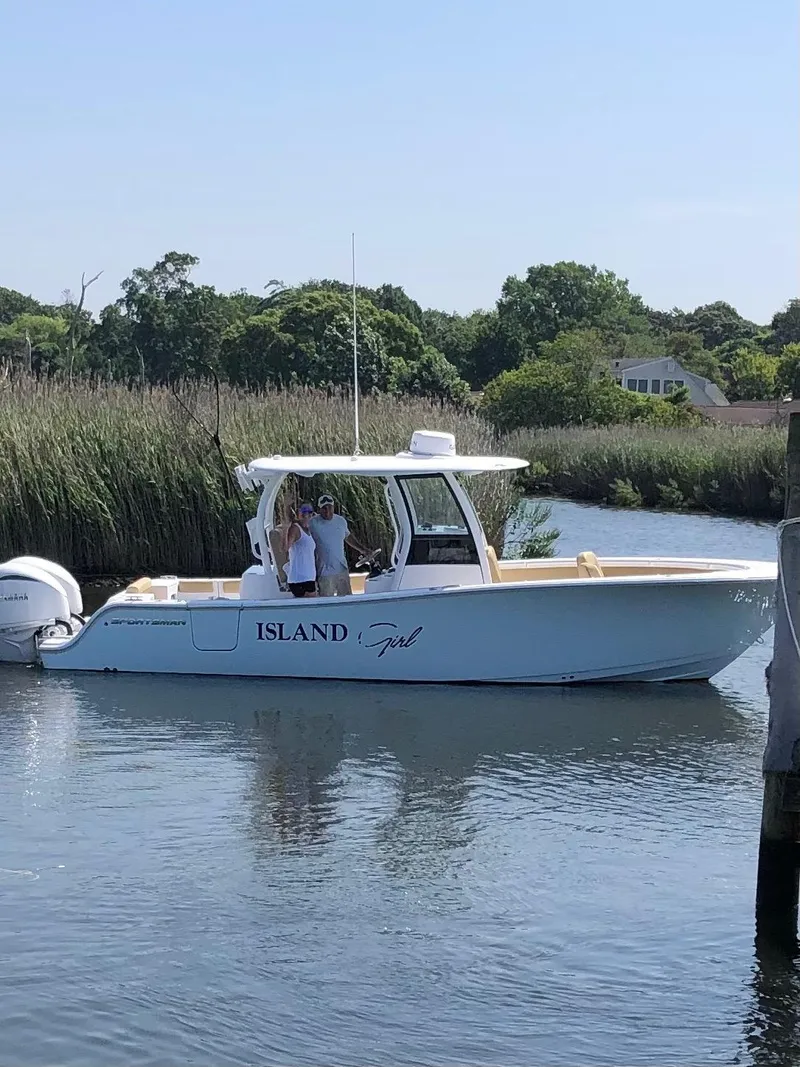 Slide: The Image of 2023 Sportsman Open 282 Center Console boat on a calm river. - 1