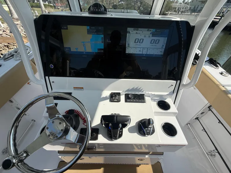 Slide: The Image of 2023 Sportsman Open 282 Center Console dashboard with steering wheel and navigation screens. - 36
