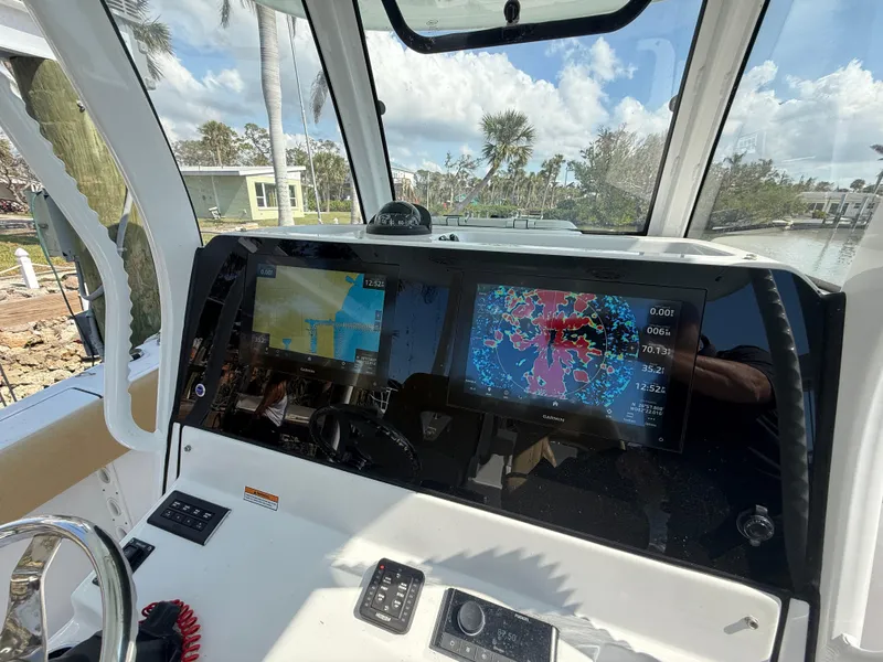 Slide: The Image of 2023 Sportsman Open 282 Center Console dashboard with navigation screens and controls. - 30