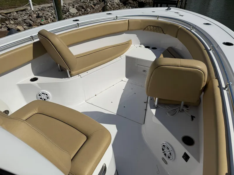 Slide: The Image of 2023 Sportsman Open 282 Center Console boat interior with tan seating and white deck. - 49
