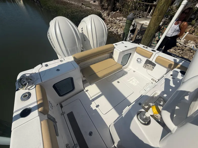 Slide: The Image of 2023 Sportsman Open 282 Center Console boat with dual engines and spacious deck. - 9