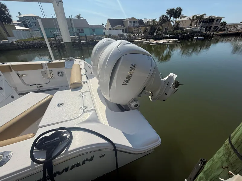 Slide: The Image of 2023 Sportsman Open 282 Center Console boat with Yamaha outboard motor docked. - 5