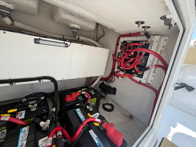 Slide: The Image of 2023 Sportsman Open 282 Center Console battery compartment with wiring and electrical components. - 28