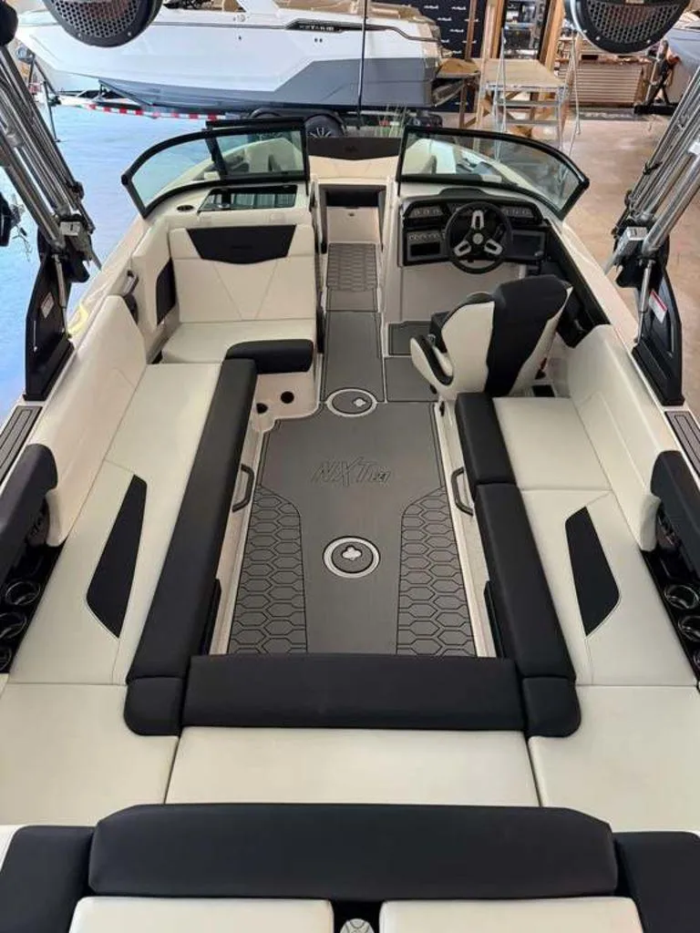 Slide: The Image of 2025 MasterCraft NXT24 boat interior with sleek seating and modern dashboard design. - 10