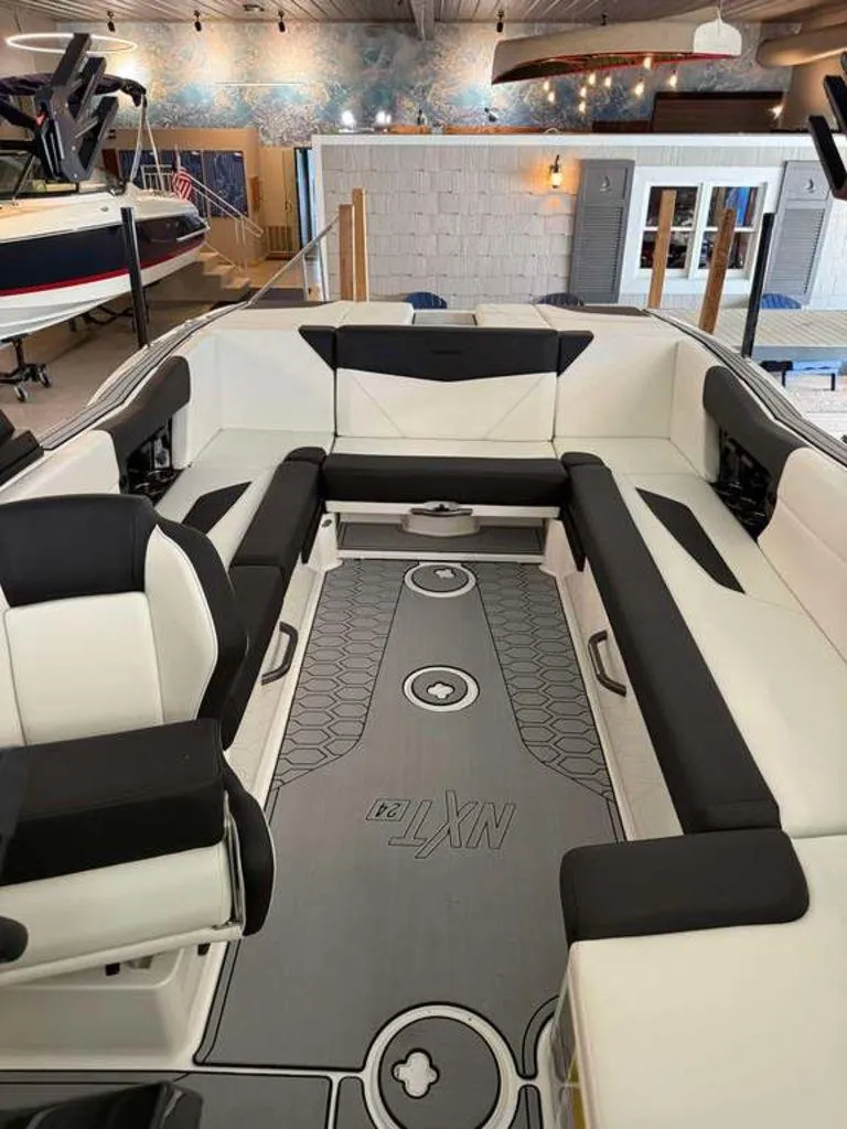 Slide: The Image of 2025 MasterCraft NXT24 boat interior with sleek seating and modern design. - 11