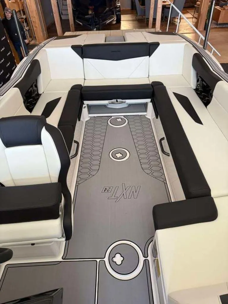 Slide: The Image of 2025 MasterCraft NXT24 boat interior with sleek seating and modern design. - 3