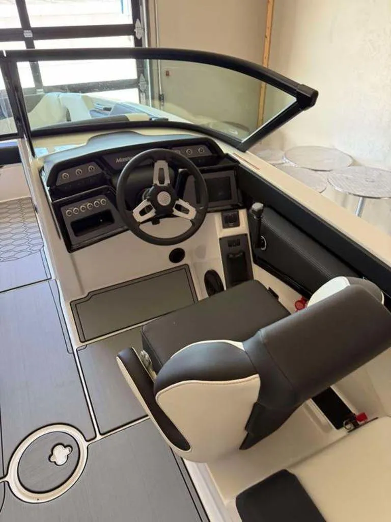 Slide: The Image of 2025 MasterCraft NXT24 boat interior with steering wheel and dashboard controls. - 4