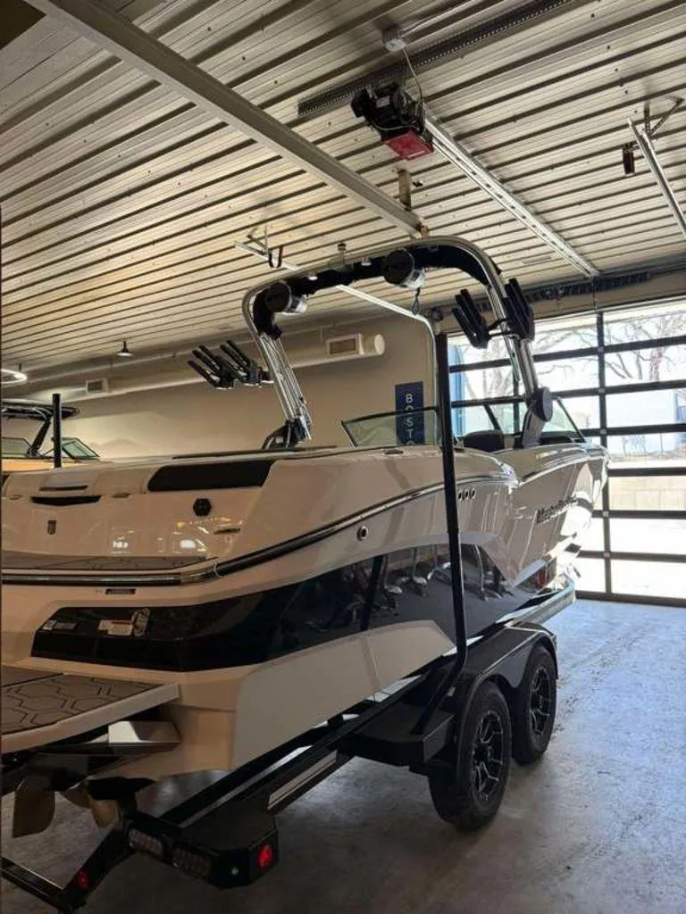 Slide: The Image of 2025 MasterCraft NXT24 boat on trailer in a garage setting. - 5