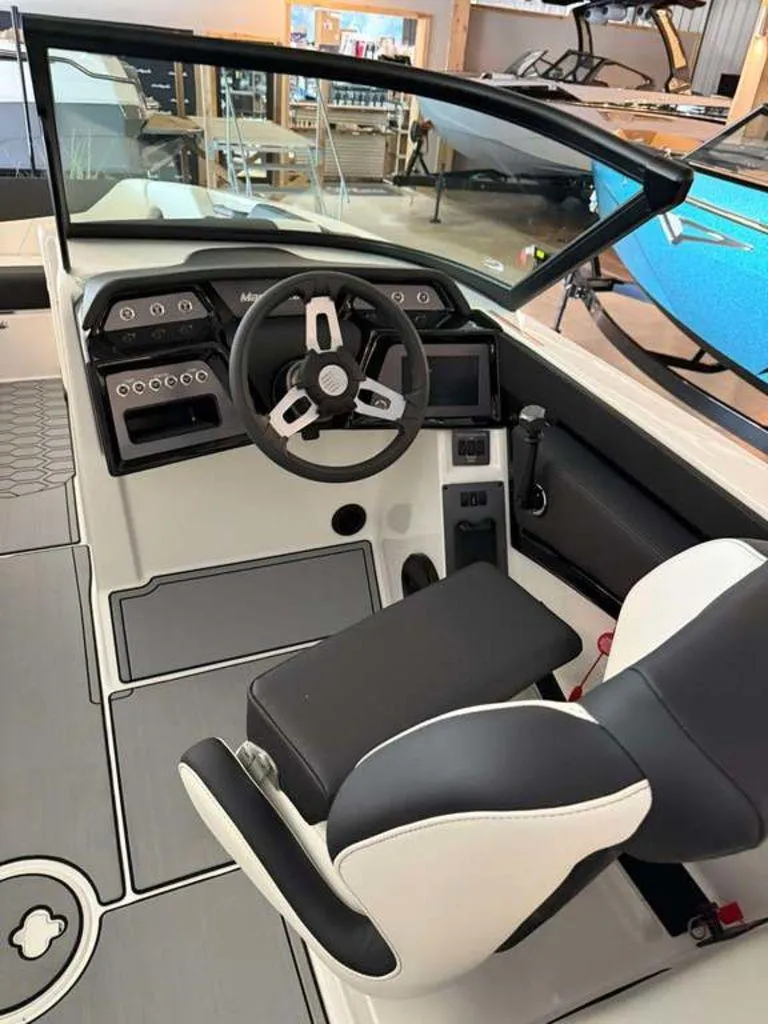 Slide: The Image of 2025 MasterCraft NXT24 boat interior with modern steering and dashboard controls. - 8
