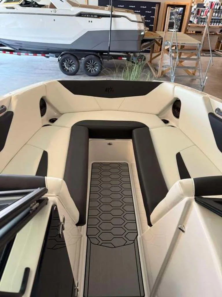 Slide: The Image of 2025 MasterCraft NXT24 boat interior with sleek seating and modern design. - 9